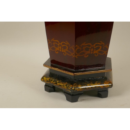 43 - An Oriental red lacquered table lamp with ceramic top, 70cm high