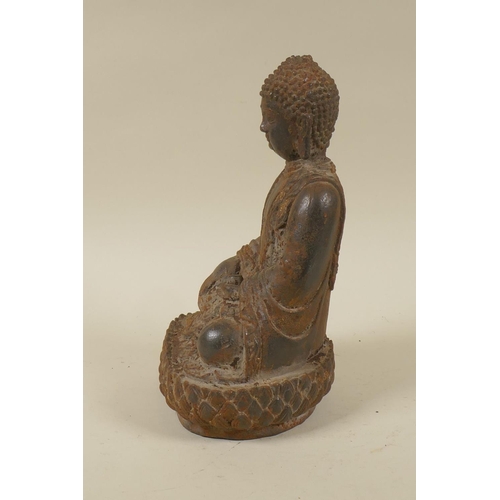 47 - An Oriental cast iron figure of Buddha seated upon a lotus throne, 22cm high