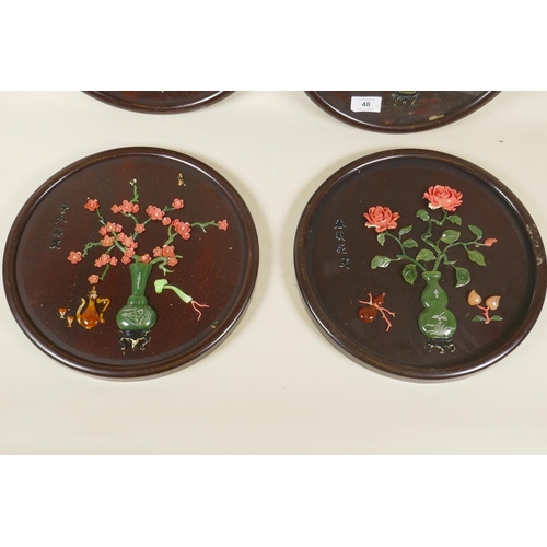 48 - Four Chinese lacquered roundel plaques with raised decoration, AF, 32cm diameter