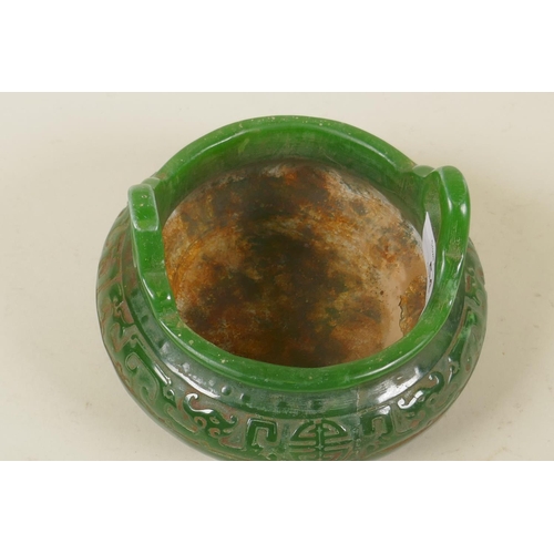 54 - A Chinese green hardstone two handled censer, the body with carved archaic style decoration, 14cm di... 