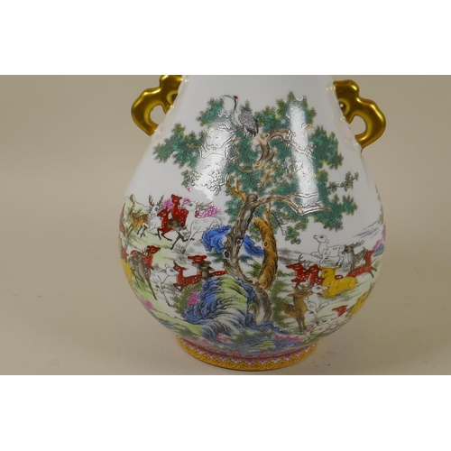 57 - A Chinese ceramic vase with gilt handles, decorated with a herd of deer under cypress trees and an i... 