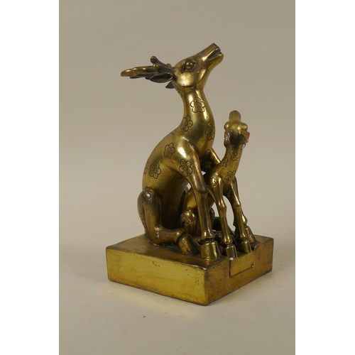 59 - A Chinese brass seal in the form of two deer, 19cm high