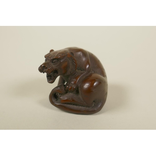 66 - A Japanese Meiji carved boxwood okimono tiger, 4cm, AF loss to ear