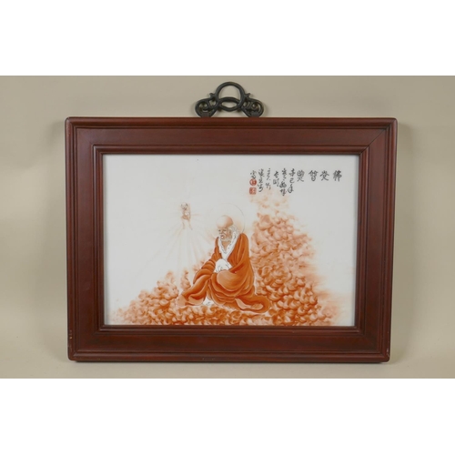 68 - A Chinese porcelain plaque depicting a red robed Lo-han, mounted in a hardwood frame, 45 x 34cm