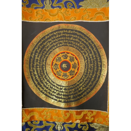 71 - A Tibetan hand painted mandala within a silk mount, 48 x 62cm