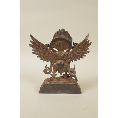 72 - A Tibetan gilt bronzed metal Garuda, double vajra mark to base, 18cm high