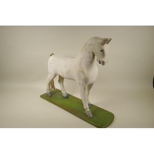 8 - A C19th Folk Art carved and painted wood toy horse, 47cm high x 54cm long