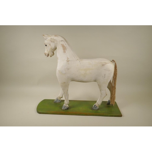 8 - A C19th Folk Art carved and painted wood toy horse, 47cm high x 54cm long