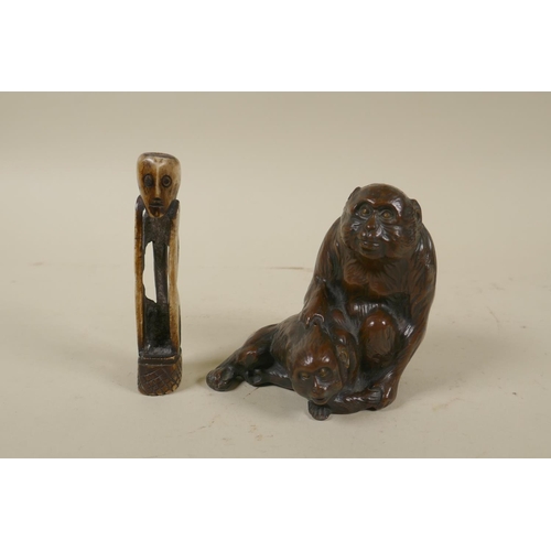 80 - A Japanese bronzed metal okimono of monkeys, 10cm high, and a primitive carved bone figure