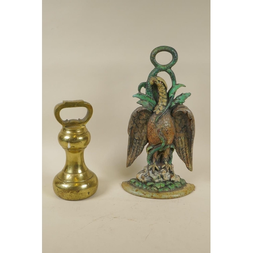 86 - A Victorian brass 14lb bell weight, and a painted cast iron eagle and serpent door stop, 35cm high