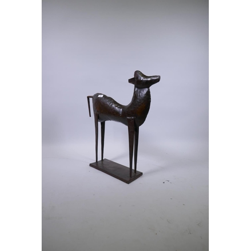 93 - A patinated metal figure of a standing deer, 74cm high