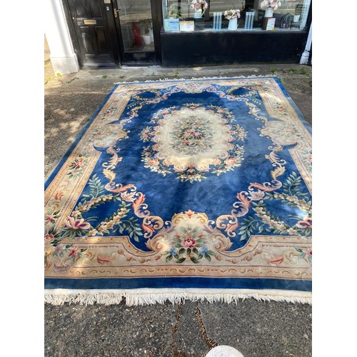 1103 - A large Chinese wool carpet with traditional design, 440 x 305cm