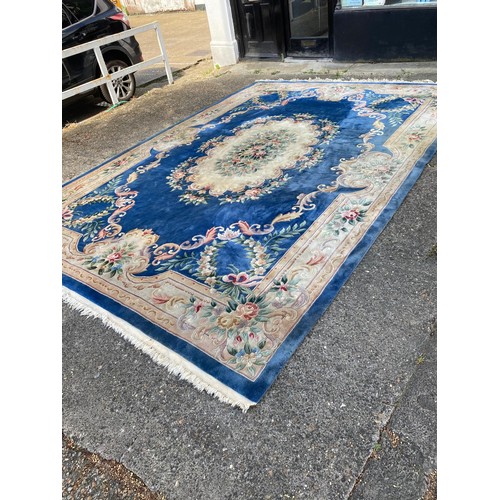 1103 - A large Chinese wool carpet with traditional design, 440 x 305cm