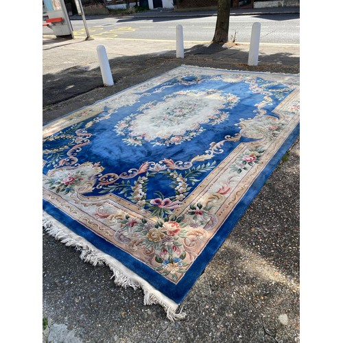 1103 - A large Chinese wool carpet with traditional design, 440 x 305cm