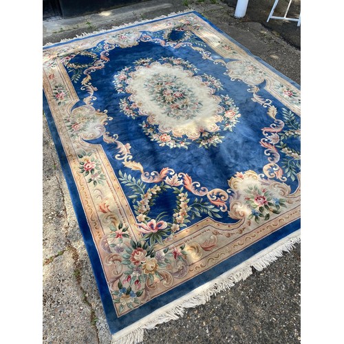 1103 - A large Chinese wool carpet with traditional design, 440 x 305cm