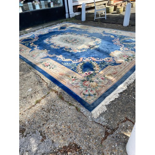 1103 - A large Chinese wool carpet with traditional design, 440 x 305cm