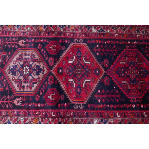 1185 - A rich ground full pile hand woven village runner from the Hamadan region, 110 x 306cm