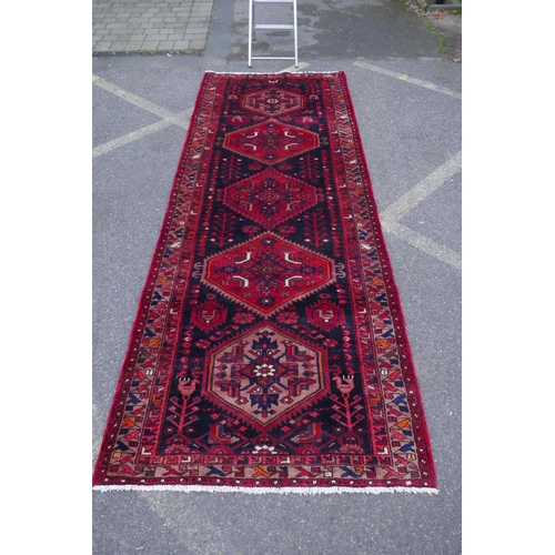 1185 - A rich ground full pile hand woven village runner from the Hamadan region, 110 x 306cm