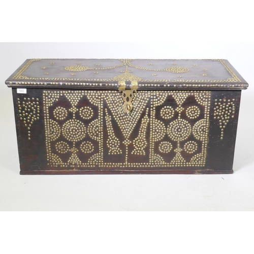 1002 - A Zanzibar hard wood chest with brass stud decoration and carrying handles, 101 x 45 x 44cm