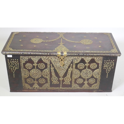 1002 - A Zanzibar hard wood chest with brass stud decoration and carrying handles, 101 x 45 x 44cm