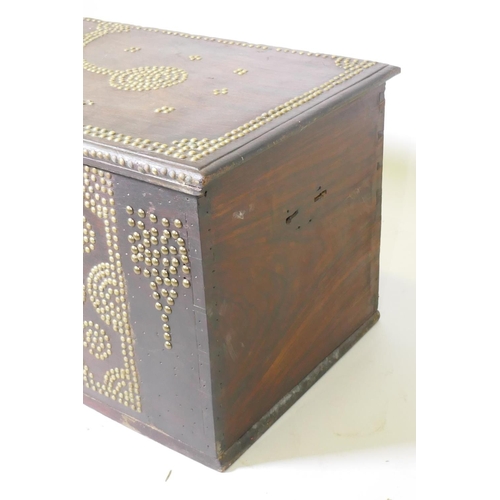 1002 - A Zanzibar hard wood chest with brass stud decoration and carrying handles, 101 x 45 x 44cm