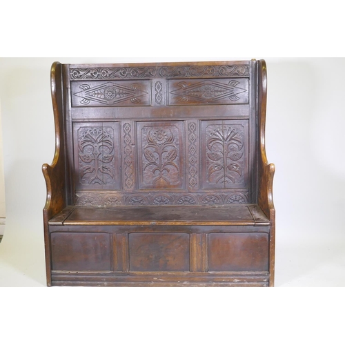 1004 - C18th oak settle with carved panelled back, lift up seat over three plain panels, adaptions, 138 x 4... 