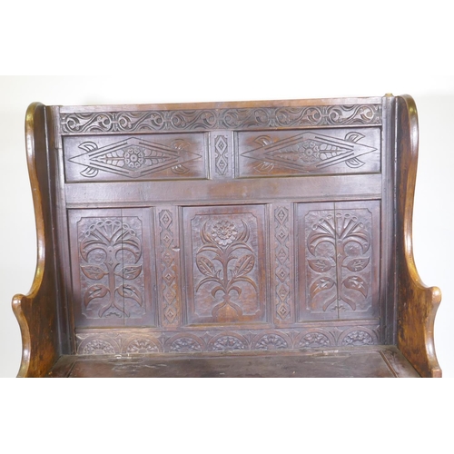 1004 - C18th oak settle with carved panelled back, lift up seat over three plain panels, adaptions, 138 x 4... 