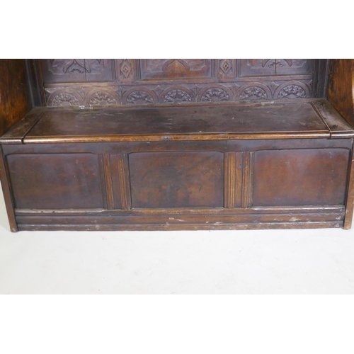 1004 - C18th oak settle with carved panelled back, lift up seat over three plain panels, adaptions, 138 x 4... 