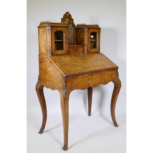 1005 - A Victorian inlaid burr walnut bureau de dame with ormolu mounts, shaped mirror flanked by two glaze... 