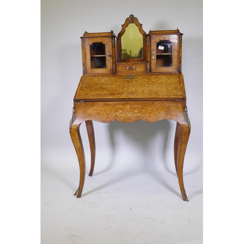 1005 - A Victorian inlaid burr walnut bureau de dame with ormolu mounts, shaped mirror flanked by two glaze... 