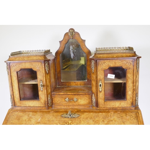 1005 - A Victorian inlaid burr walnut bureau de dame with ormolu mounts, shaped mirror flanked by two glaze... 