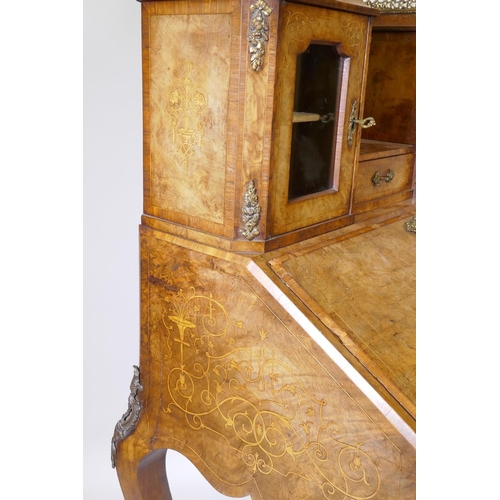 1005 - A Victorian inlaid burr walnut bureau de dame with ormolu mounts, shaped mirror flanked by two glaze... 