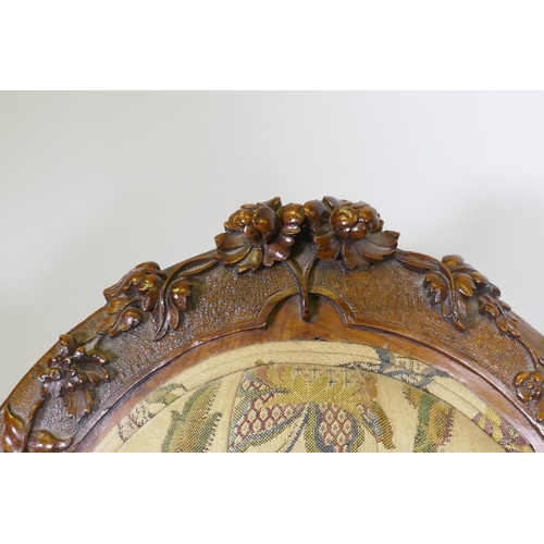 1012 - A good Victorian shaped back walnut show frame armchair with finely carved floral and scroll decorat... 