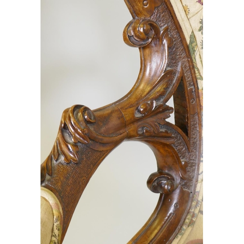 1012 - A good Victorian shaped back walnut show frame armchair with finely carved floral and scroll decorat... 