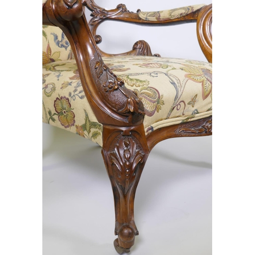 1012 - A good Victorian shaped back walnut show frame armchair with finely carved floral and scroll decorat... 