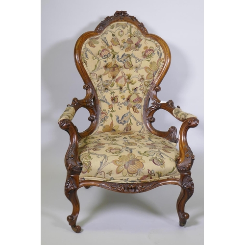 1012 - A good Victorian shaped back walnut show frame armchair with finely carved floral and scroll decorat... 