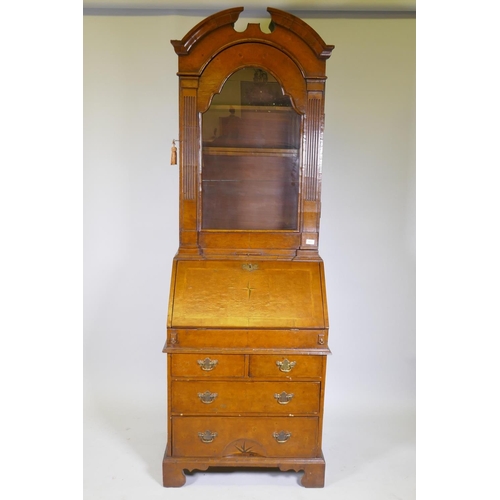 1017 - A Queen Anne style burr walnut dome top bureau bookcase, the upper section with broken arch pediment... 