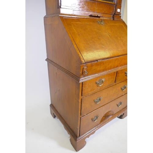 1017 - A Queen Anne style burr walnut dome top bureau bookcase, the upper section with broken arch pediment... 