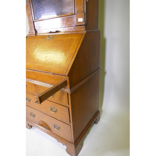 1017 - A Queen Anne style burr walnut dome top bureau bookcase, the upper section with broken arch pediment... 