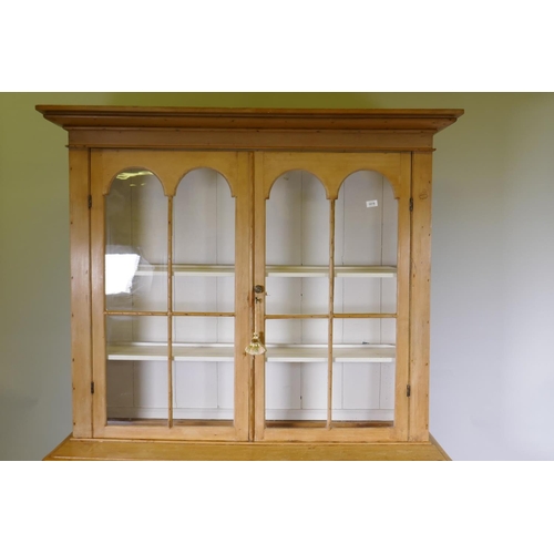 1018 - Victorian stripped pine dresser/display cabinet, the upper section with a pair of arched glazed door... 