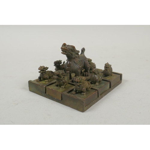 103 - A Chinese bronze kylin seal set with eight smaller kylin seals, 8x 9cm