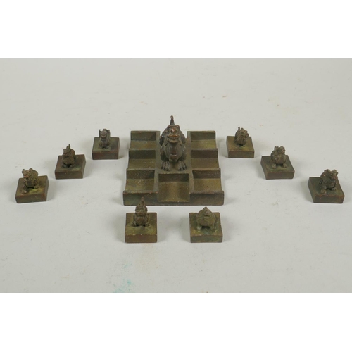 103 - A Chinese bronze kylin seal set with eight smaller kylin seals, 8x 9cm