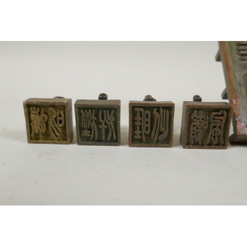 103 - A Chinese bronze kylin seal set with eight smaller kylin seals, 8x 9cm