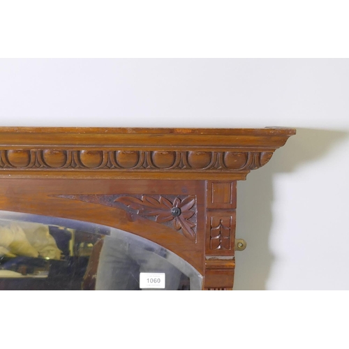 1060 - Edwardian walnut over mantel mirror with carved egg and dart cornice over an arched shaped bevelled ... 