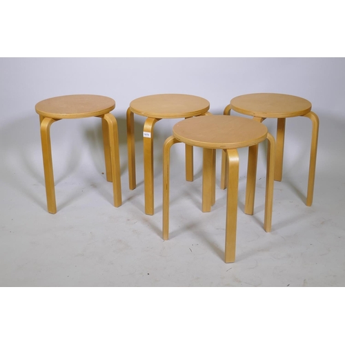 1079 - After Alvar Aalto, a set of four Model 60 style bentwood stacking stools, 35cm diameter, 45cm high