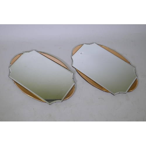 1080 - A pair of Art Deco wall mirrors with rose coloured borders, 64 x 41cm