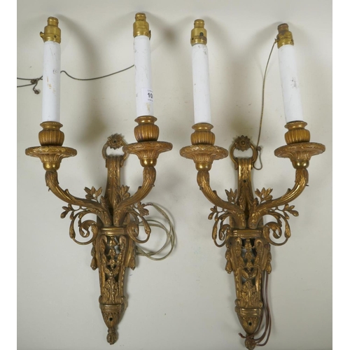 1084 - A pair of French bronze two branch wall sconces, wired for electricity, 53cm long