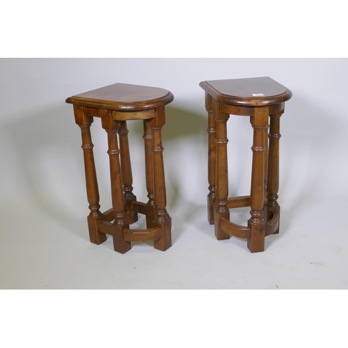 1087 - A pair of wood end tables, raised on turned supports, 64cm high