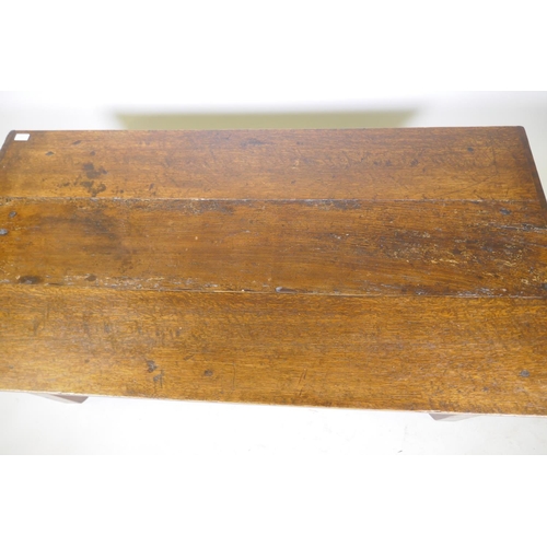 1099 - An antique oak plank top coffee table, 43 x 73cm, 49cm high