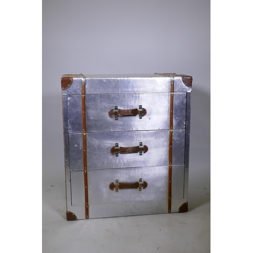 1118 - A metal veneered and leather mounted aviation style chest of three drawers, with carrying handles, 7... 